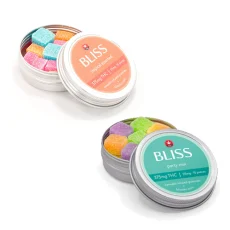 Two tins of Bliss weed gummies, featuring Tropical Assorted and Party Mix flavors. The gummies are brightly colored in pink, blue, yellow, green, and purple
