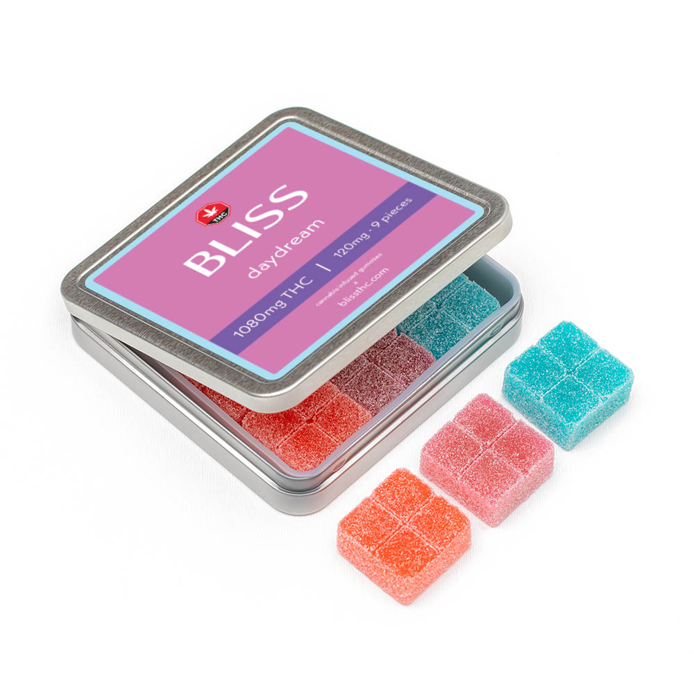Bliss Sweet Escape gummies in a square tin featuring yellow, green, and orange gummies, each containing 120mg THC