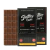 Close-up of two Shatter Bars 1200mg THC chocolate bars in Milk Chocolate (Sativa and Indica), with the full bar showing its 50mg per square segments.