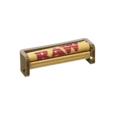 A RAW 79mm Pre Roll Machine made from eco-friendly German hemp plastic. The machine is shown with a RAW rolling paper ready for use, designed to fit 1¼ rolling papers. This rolling machine ensures consistent and perfectly rolled joints with minimal effort, making it ideal for both beginners and experienced smokers