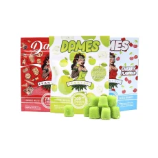 Image showing three Dames Edibles Gummy Co 200mg THC Gummies packages in Cherry, Green Apple, and Cherry Cola flavors, each featuring cannabis-infused gummies with 20mg of THC per piece. The packaging highlights bold, vibrant fruit designs