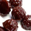 Close-up of Dames Gummy Co. gummies from Weed Market, featuring dark berry-shaped mushroom edibles with a glossy finish