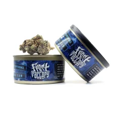 Frost Factory Cold Cured Quads in a 14g tin with a cannabis flower resting on top of the can, showcasing premium cannabis quality