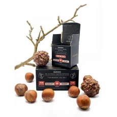 High Heals Hazelnut Delight THC truffles 100mg edibles box open with hazelnut truffles and whole hazelnuts placed around the packaging. The box displays '100mg THC per truffle' and '400mg THC total' along with medical use warnings