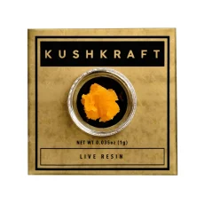Packaging image of Kush Kraft Top Shelf Live Resin in a small glass jar, displayed on gold and black packaging. The live resin has a sticky, yellow-orange appearance, indicating its high terpene content.