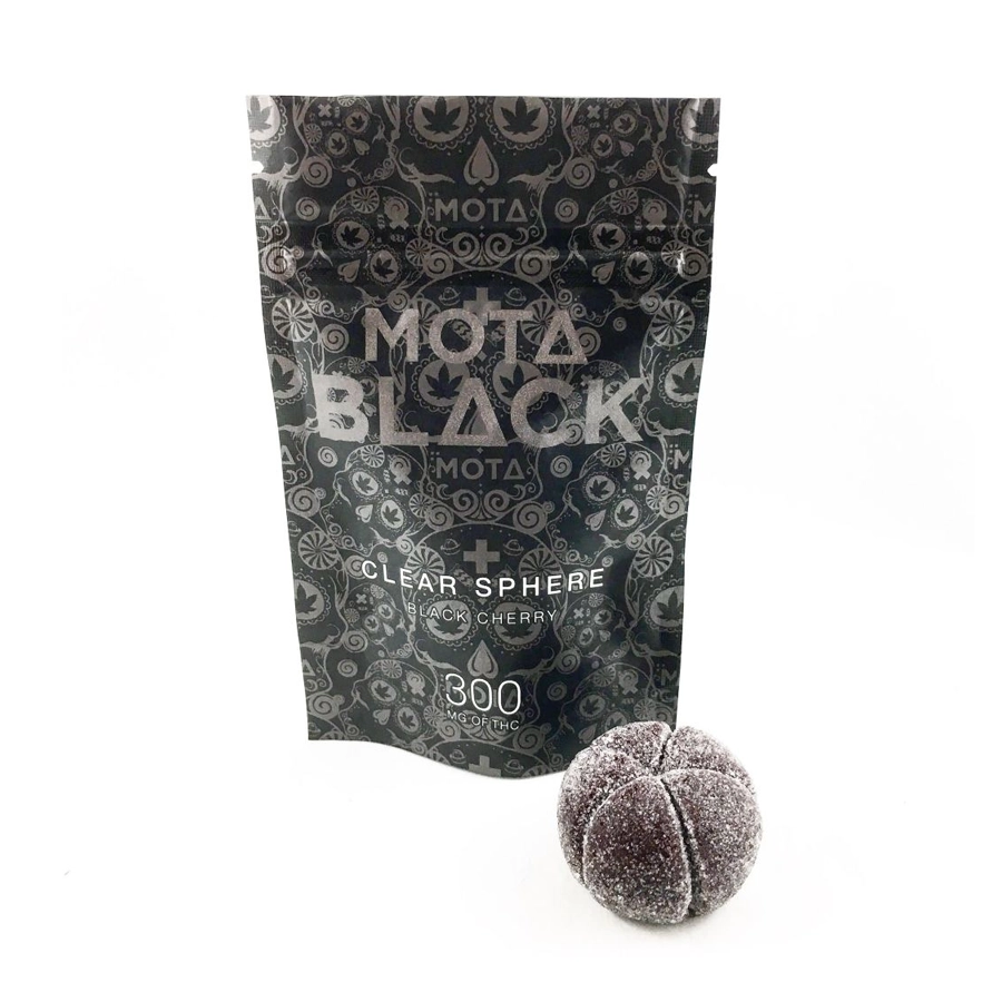 The Mota Black THC Clear Sphere gummy next to the opened black Mota Black package, clearly showing the 300mg THC content and black cherry flavor labeling on the packaging