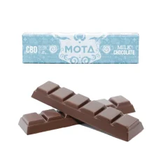 A MOTA CBD Chocolate Bar with packaging in light blue featuring the MOTA logo and CBD dosage information. The image shows the chocolate bar itself, which is divided into six pieces, placed in front of the packaging. The chocolate bar contains 85mg of CBD