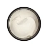 Open jar of MOTA Green Cream showing smooth, white cannabis-infused lotion.