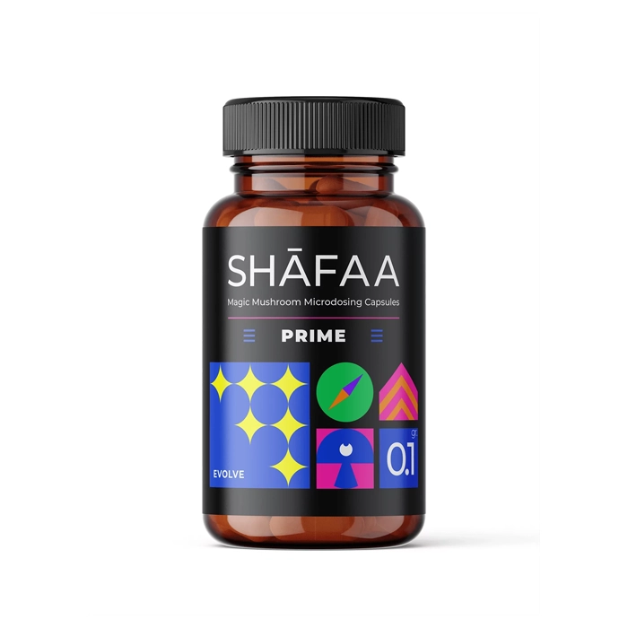 A brown bottle of Shafaa Prime Microdosing Psilocybin Capsules featuring a black label with geometric designs and the product name "Prime." The label also includes "100mg Psilocybin Mushrooms" for cognitive and memory support