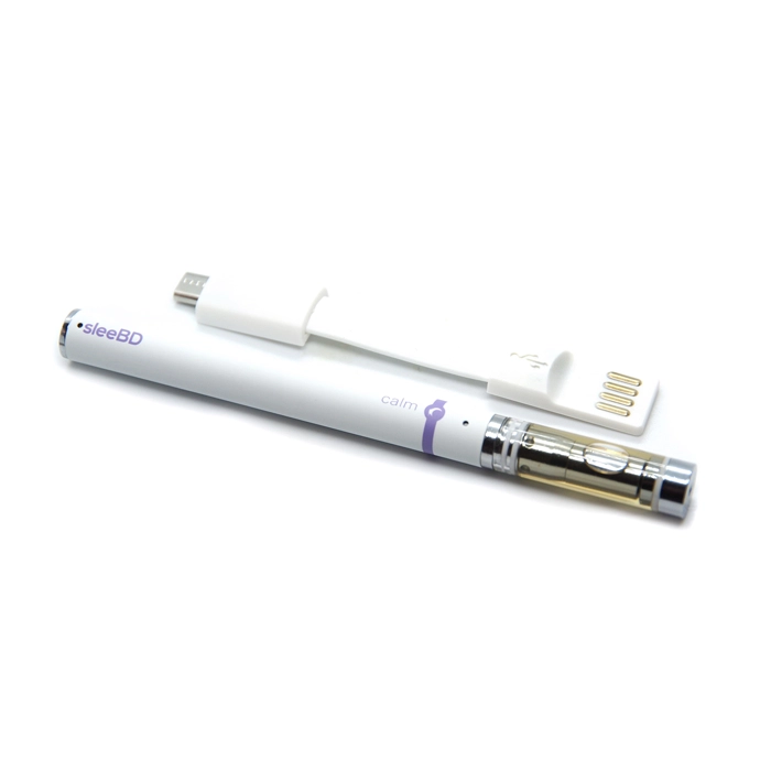 SleeBD Calm Full Spectrum CBD Vape pen placed alongside its USB charger. The sleek white pen is labeled "calm" with lavender detailing, and the cartridge is filled with the CBD oil, ready for use.