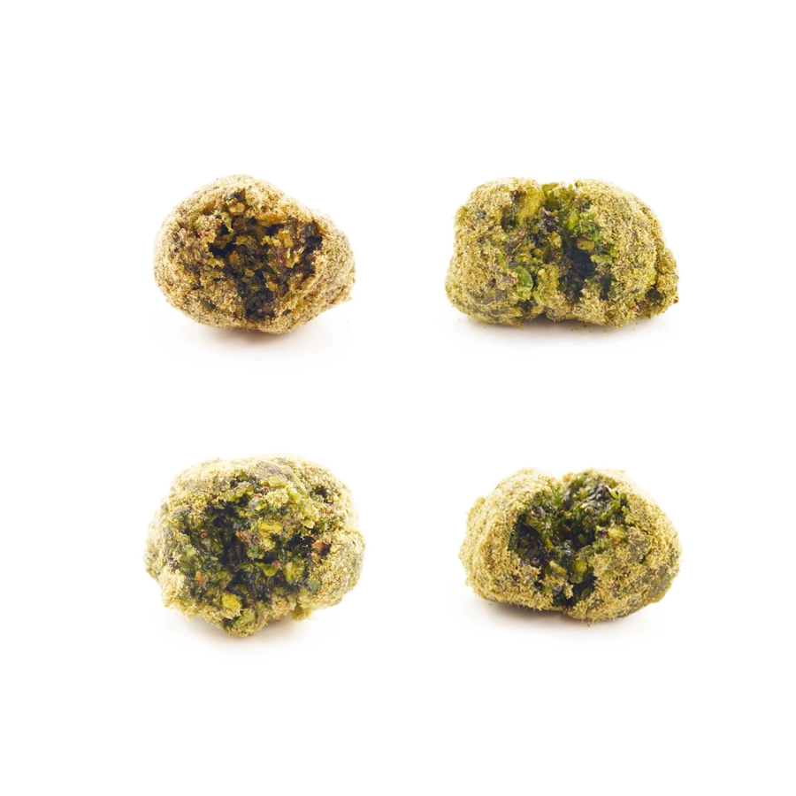 Close-up of To The Moon Indica Moon Rocks: Four indica moon rocks in a close-up shot showing the detailed kief coating and texture.