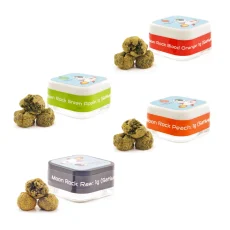 Assorted To the Moon Cannabis Sativa Moon Rocks containers featuring flavors like Green Apple, Blood Orange, Raw, and Peach, with kief-covered Moon Rocks beside each container