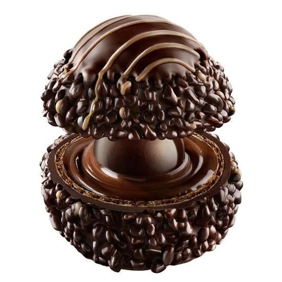 Close-up of a dark chocolate truffle, revealing its interior layers with a crunchy exterior and creamy center, representing High Heals Dark Bliss THC truffles