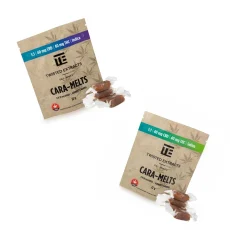 Twisted Extracts caramelts edibles packaging for both Indica and Sativa varieties, each with a 1:1 ratio of 40mg THC and 40mg CBD. The Indica package has a purple banner, while the Sativa package features a green banner. Both are displayed in brown kraft paper bags with unwrapped caramel pieces placed beside them