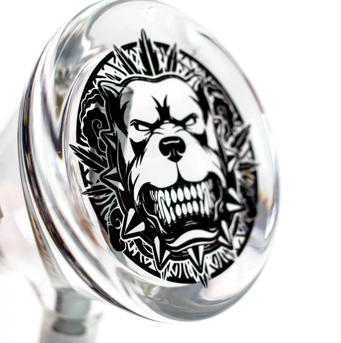 Close-up of a dog design at the base of the Weneed 12" Nice Glass Bong, featuring a fierce-looking dog with a spiked collar engraved on the bottom.