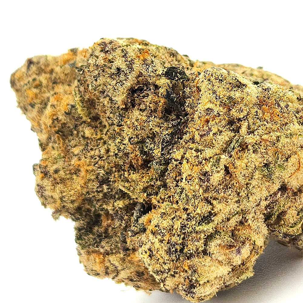 A macro shot of the Ice Cream weed strain bud, highlighting the intricate details of the trichome-coated surface, with subtle shades of green and orange threading through the structure.