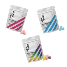 A collection of Bonafide Fruit Cubes in Blue Raspberry, Party Pack, and Watermelon flavors, each with sleek white packaging and matching colorful cubes, THC infused.