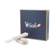 A sleek Sesh Prerolls box in blue with a gold outline, an astronaut and rocket logo. Three pre-rolls are placed in front of the closed box for display.