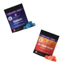 Two Twisted Extracts High Dose Sour Twisted Singles packages. The Blueberry flavor is shown with blue gummy cubes and the Nectarine Dream flavor with orange gummy cubes, displayed diagonally for a modern presentation.