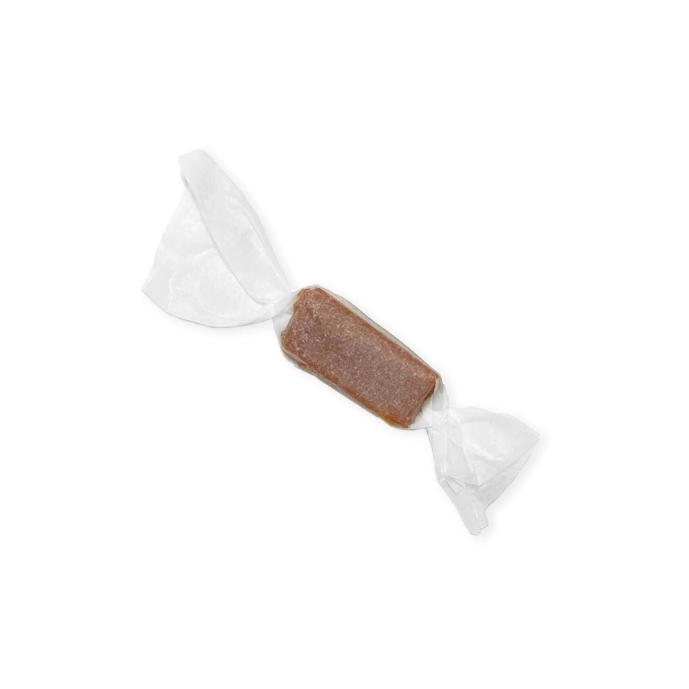 Close-up of a single wrapped Twisted Extracts salted caramel candy.