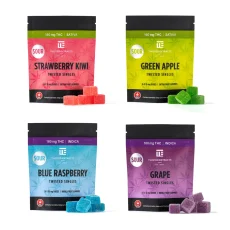 Four Twisted Extracts Twisted Singles gummy bags featuring Strawberry Kiwi, Green Apple, Blue Raspberry, and Grape flavors with colorful gummies displayed in front of each package