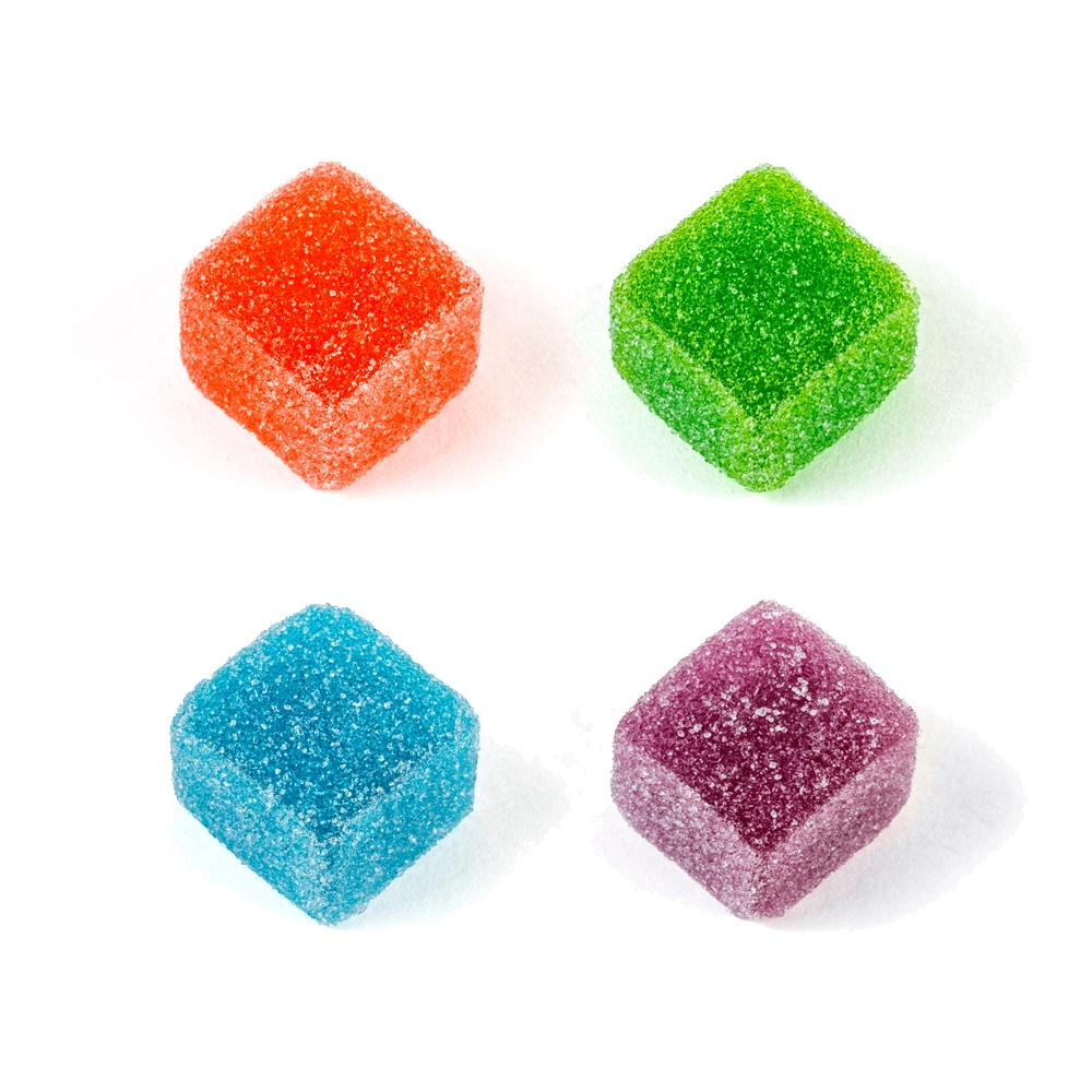 Close-up of four colorful Twisted Extracts Twisted Singles gummies, featuring red, green, blue, and purple cubes coated in sugar