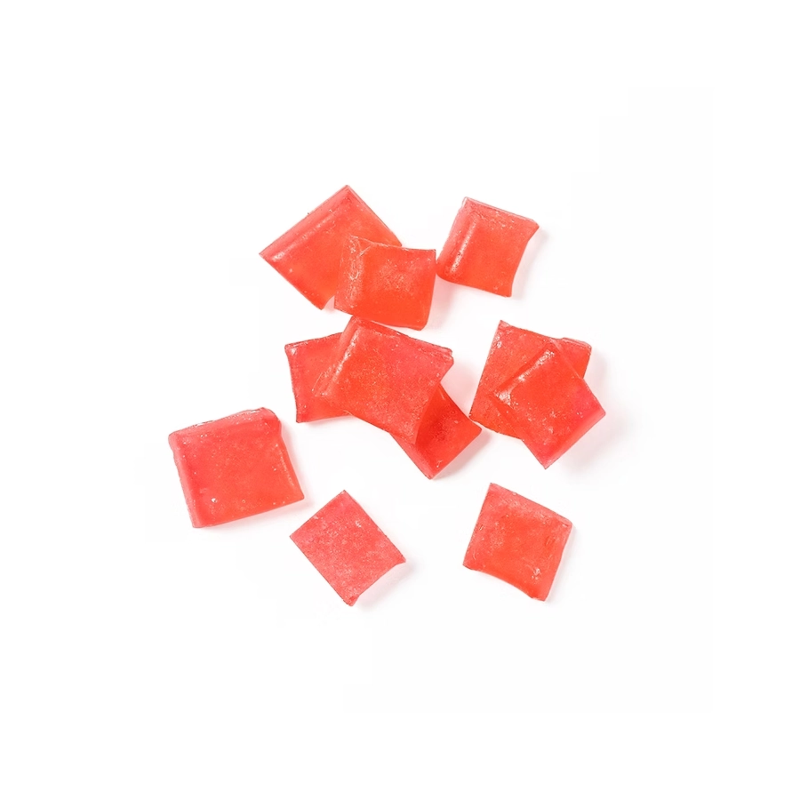 Cherry hard candy pieces scattered on a white background with a rich red color.