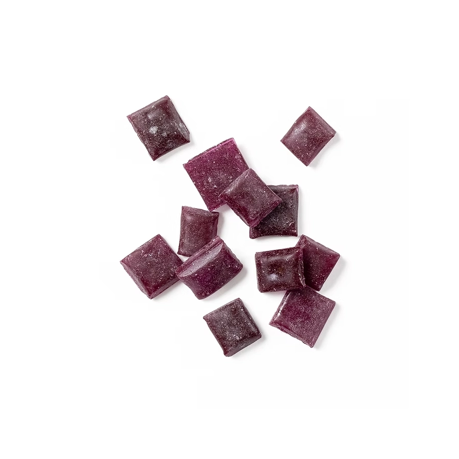 Grape hard candy pieces in deep purple arranged on a white background.