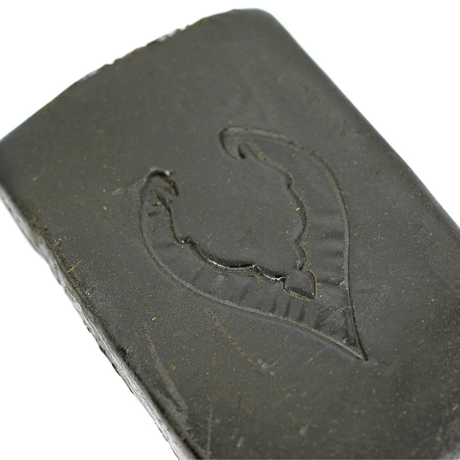 Close-up of Zen Hash showcasing its smooth texture and pressed leaf emblem.