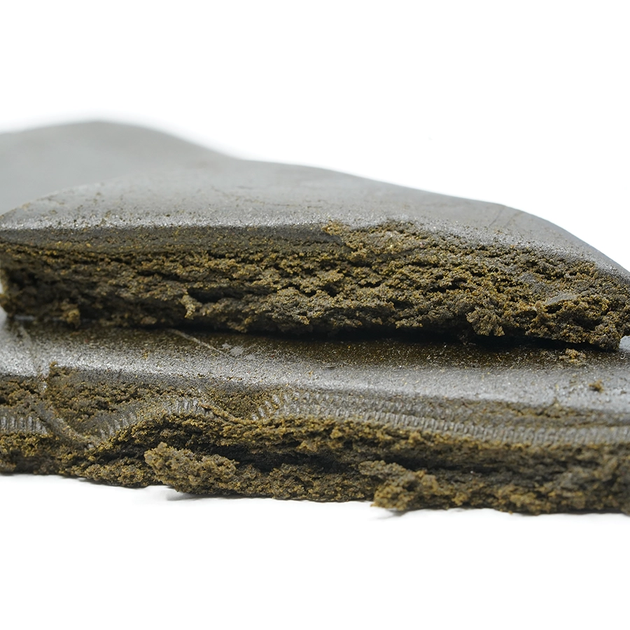 Cracked Zen Hash bar revealing its soft, crumbly interior and rich brown tone.