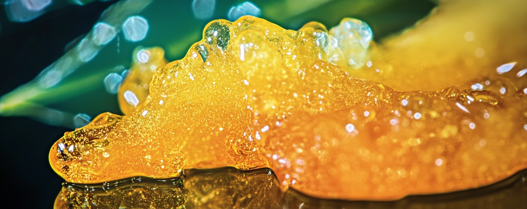Macro view of vibrant, golden live resin with a glossy, sticky texture on a reflective surface, representing top-tier cannabis extracts from Weed Market.
