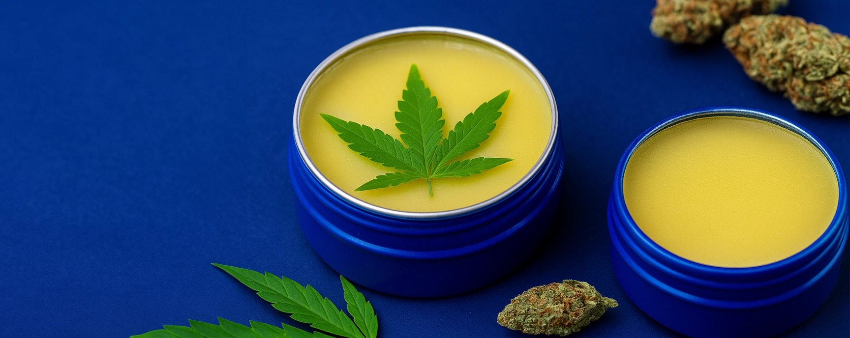 THC cream in deep blue jars with cannabis leaf and dried buds on navy background