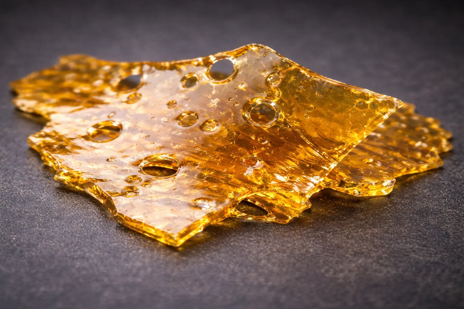 Thin translucent cannabis shatter sheet with glass-like texture, shatter vs other cannabis concentrates